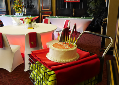 Tennis ball cart purposed as a cake table for fortieth birthday event in Ocala, Florida.