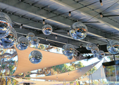 Hanging mirror disco balls for an outdoor wedding reception in Ocala, Florida.