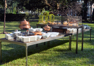 Stacked Edison tables as buffet with copper chafer dishes at an outdoor event in Ocala, Florida.