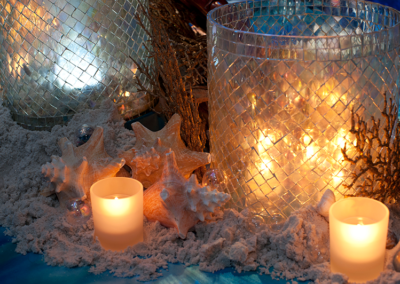 Votives, shells, and sand centerpiece for a children's under the sea themed event in Ocala, Florida.