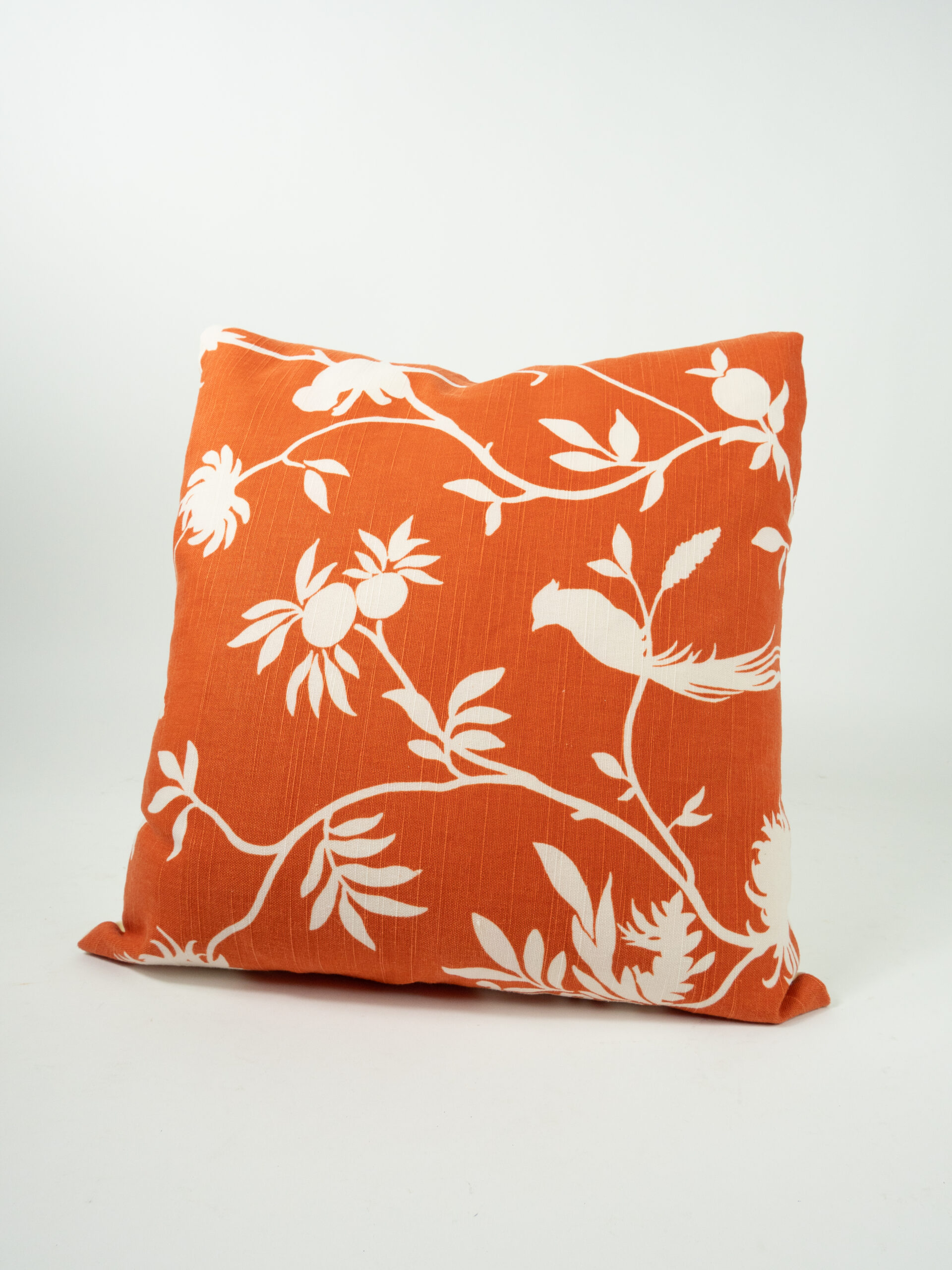 ORANGE PILLOW W/ IVORY BOTANICAL